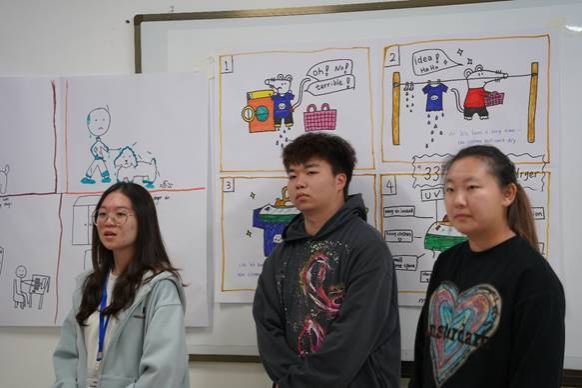 A group of people standing in front of a whiteboardDescription automatically generated