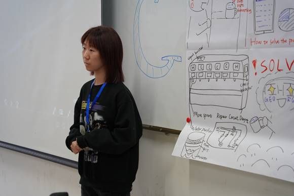 A person standing in front of a whiteboardDescription automatically generated