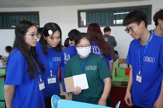 A group of people wearing blue shirtsDescription automatically generated